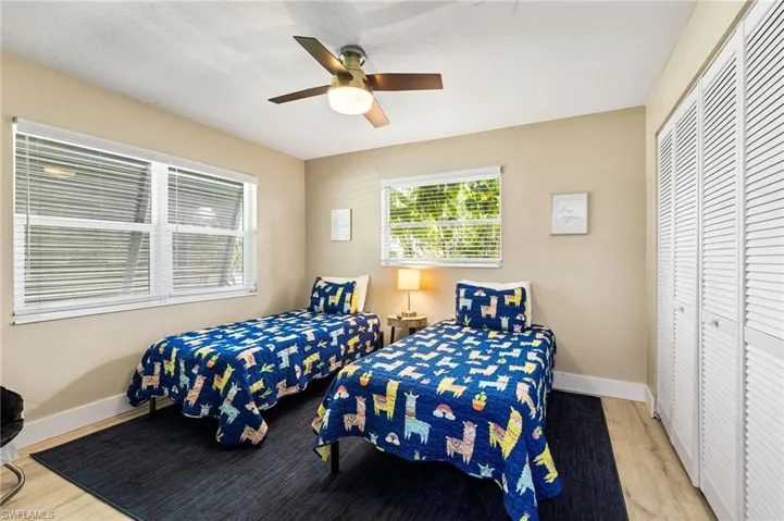 Bedroom featuring light hardwood / wood-style flooring, a closet, and ceiling fan