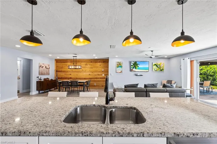 Kitchen featuring pendant lighting and wooden walls