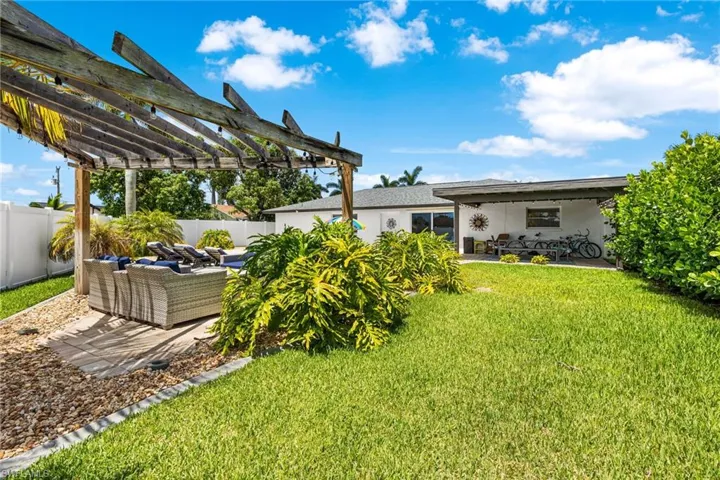 View of yard with a pergola, a patio area, and an outdoor hangout area