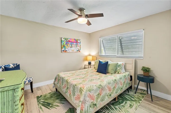 Bedroom with hardwood / wood-style flooring and ceiling fan