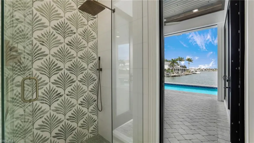 Full bathroom with a water view and a stall shower
