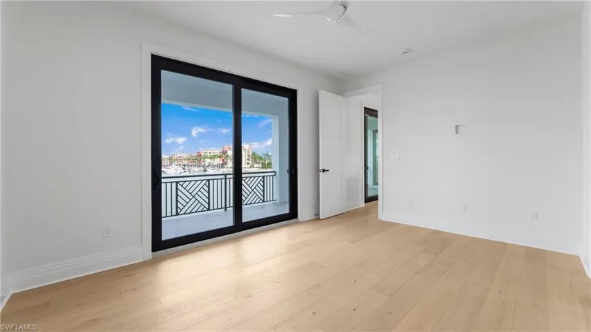 Unfurnished room featuring light wood finished floors and baseboards