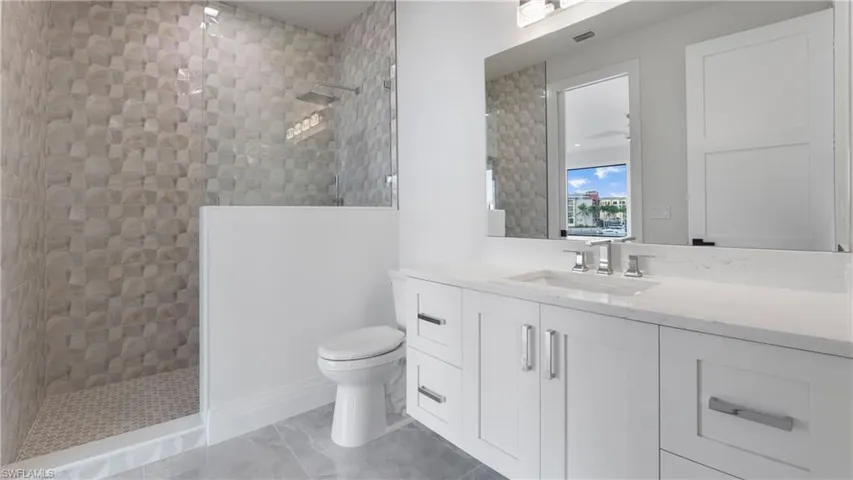 Full bath with a walk in shower and vanity