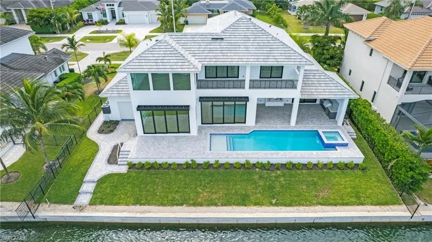 Rear view of property featuring a patio area, stucco siding, a residential view, and a fenced backyard
