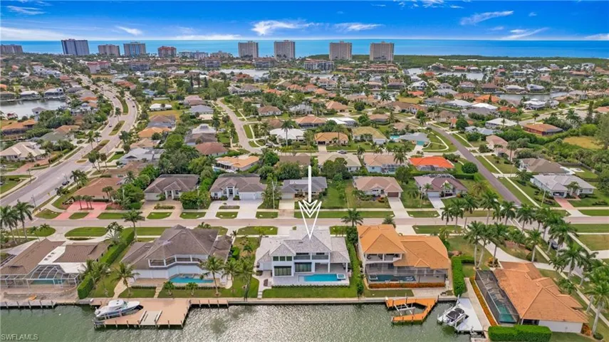 Aerial perspective of suburban area featuring a large body of water