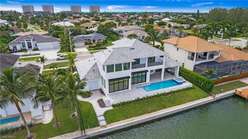 View from above of property featuring a pool area and a large body of water