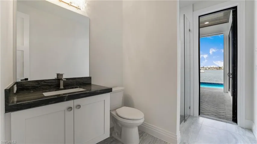 Full bath with vanity and a water view