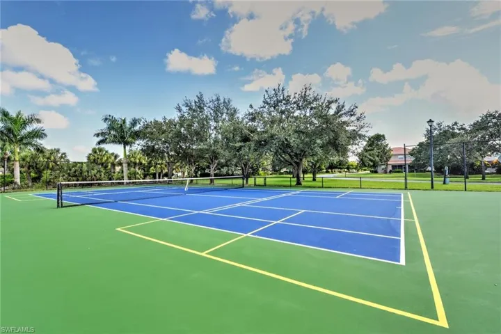 View of sport court featuring fence