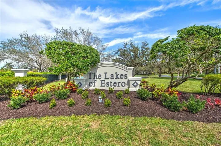 Community / neighborhood sign featuring a lawn