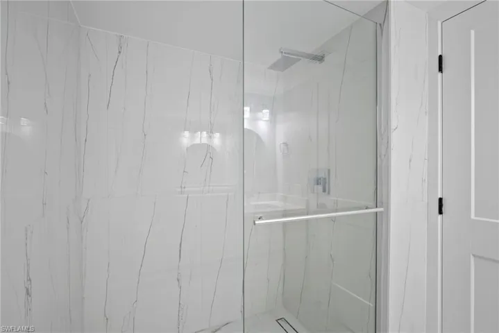 Bathroom featuring a shower with door