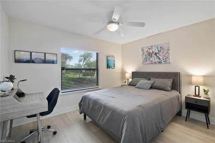 Bedroom with light hardwood / wood-style flooring and ceiling fan