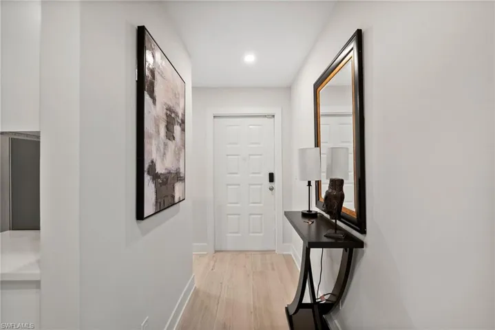 Corridor with light hardwood / wood-style floors