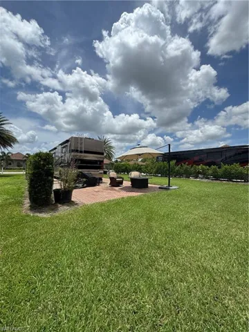 View of green lawn with a patio