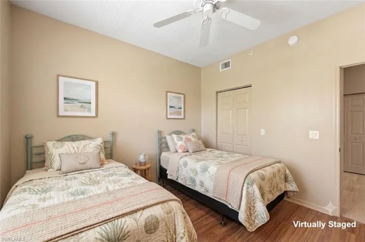 Bedroom featuring wood-finish flooring, a ceiling fan, and neutral wall tones