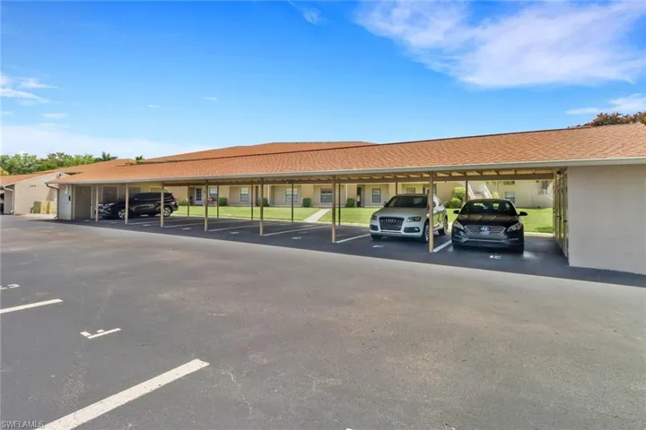 View of car parking featuring a carport