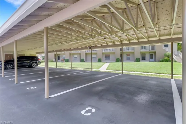 View of parking featuring a carport