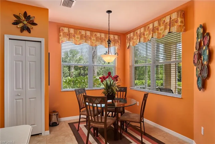 Dining area with baseboards and light tile patterned floors