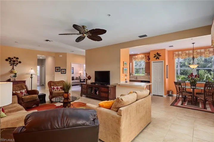 Living area featuring light tile patterned flooring and a ceiling fan