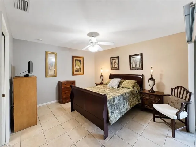 Tiled flooring, ceiling fan, and neutral wall tones
