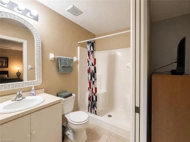 Full bathroom with a single vanity, integrated sink, built-in cabinetry, and a shower-tub combination