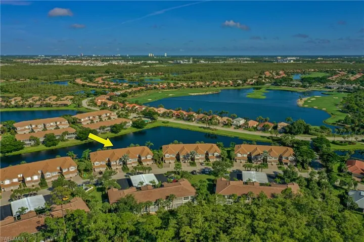 Birds eye view of property with a water view