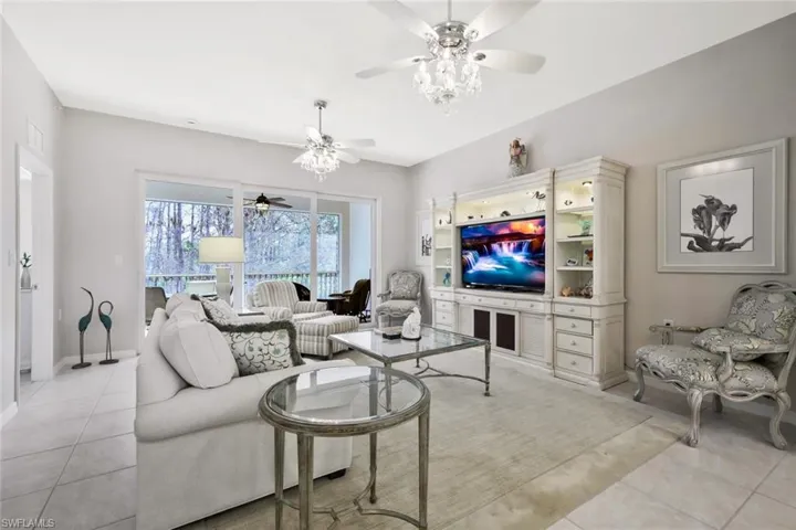 Living room featuring a ceiling fan and light tile patterned floors