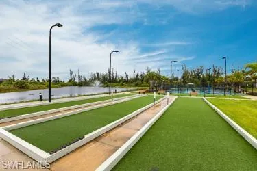 View of property's community with a game area and a water view