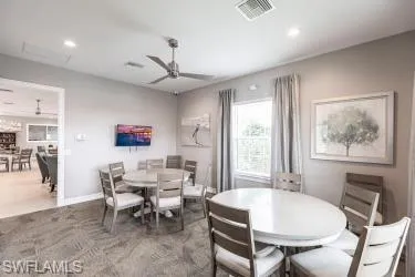 Dining room with recessed lighting and a ceiling fan