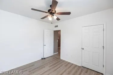 Unfurnished bedroom with light wood finished floors and ceiling fan