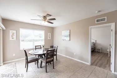Dining room with ceiling fan and light tile patterned floors