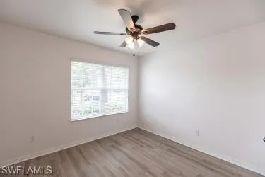 Spare room featuring wood finished floors and a ceiling fan
