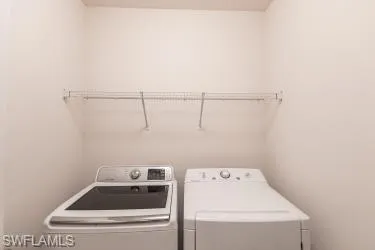 Laundry room featuring washer and clothes dryer