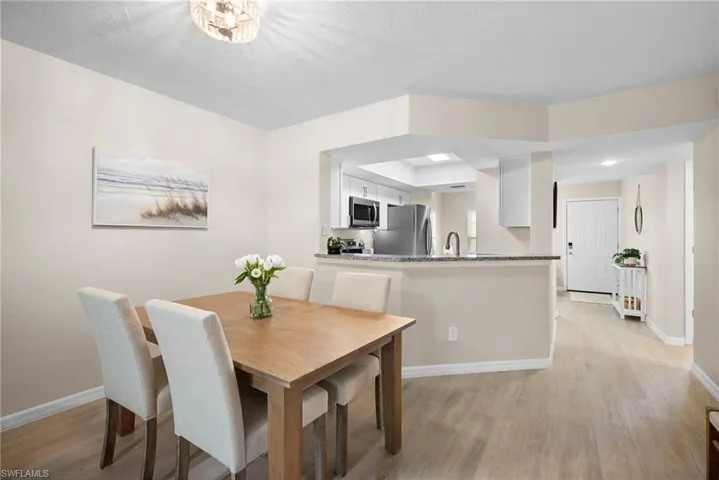 Dining area with baseboards and light wood-style floors