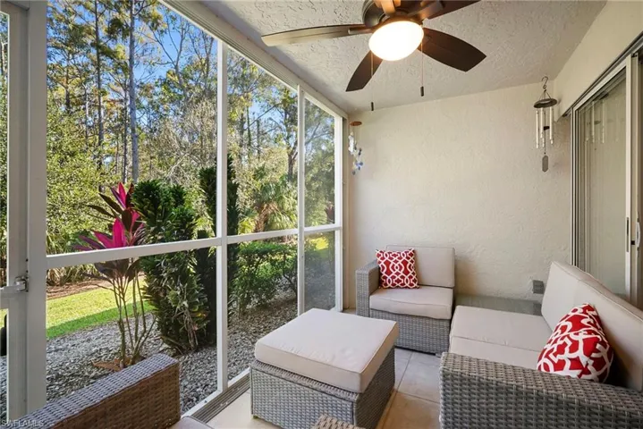 Sunroom featuring an outdoor living space and a ceiling fan