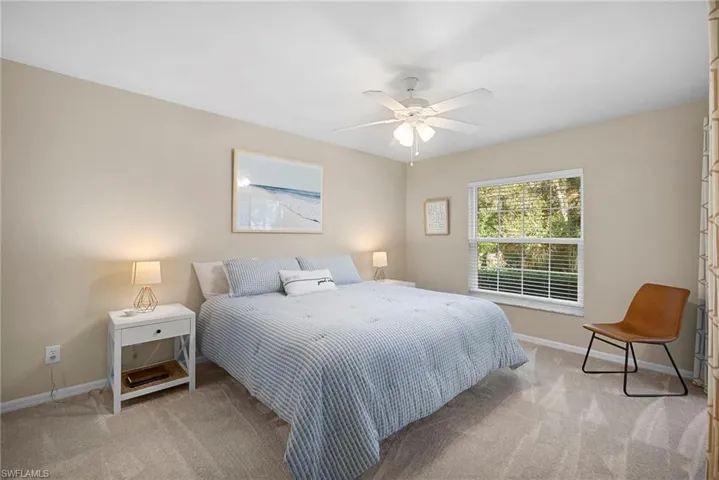 Bedroom with light colored carpet and ceiling fan