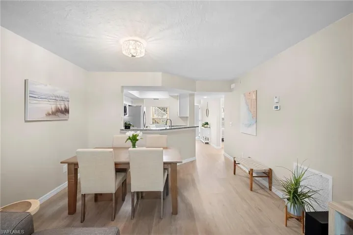 Dining space with light wood-type flooring and a textured ceiling