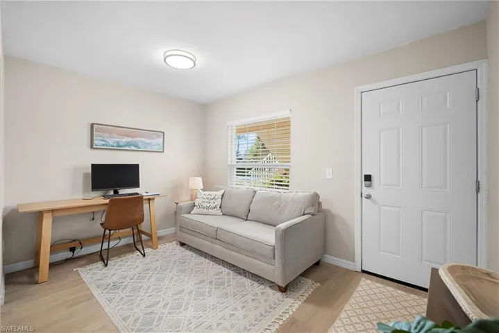 Living room featuring a desk and light wood finished floors