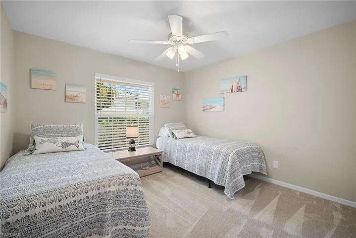 Bedroom featuring light carpet and ceiling fan