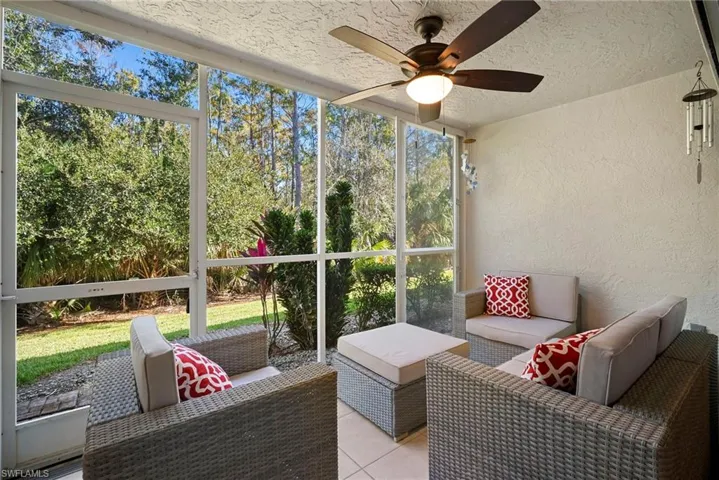 Sunroom with an outdoor living space and a ceiling fan