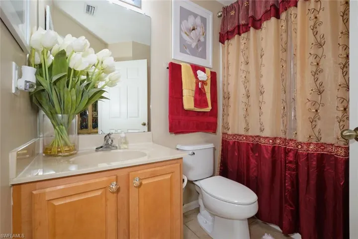 Bathroom with vanity, tile patterned floors, and toilet