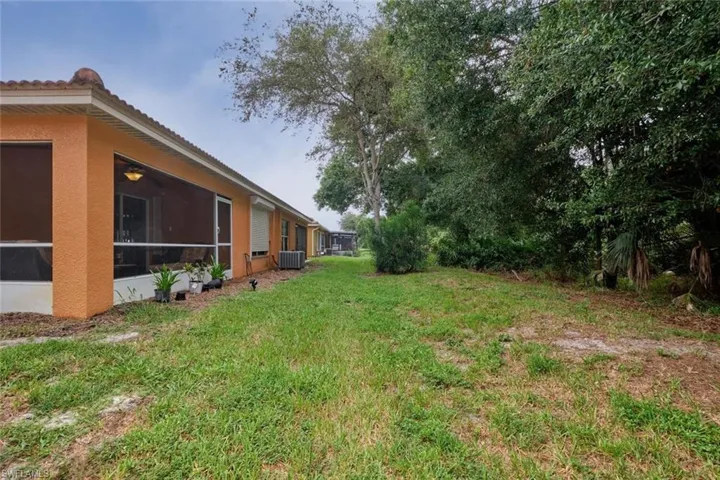 View of yard with central air condition unit and a sunroom