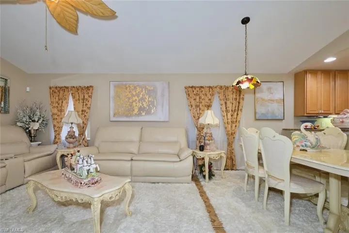 Living room with light carpet and ceiling fan
