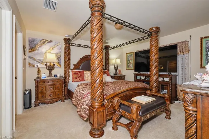 Bedroom featuring light colored carpet