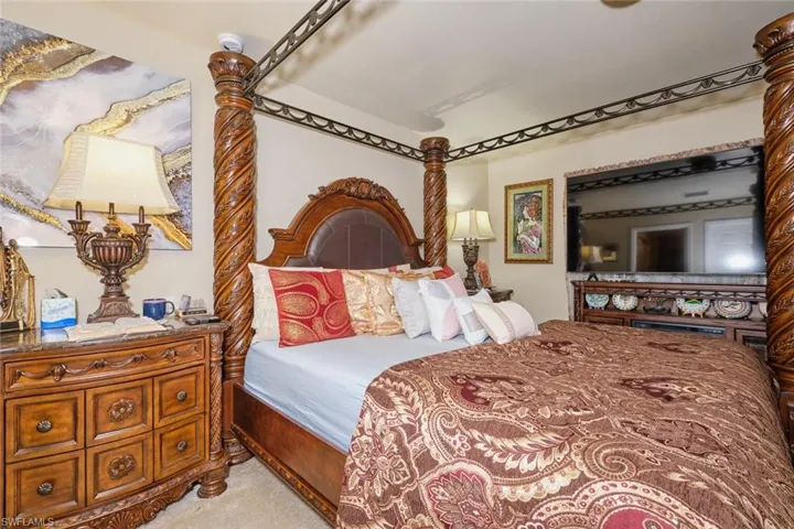 Bedroom featuring light carpet