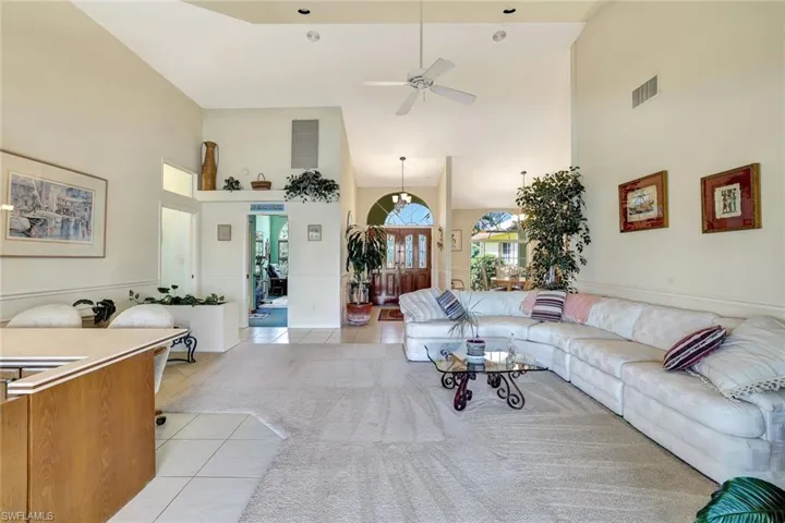 Living & dining spaces under soaring vaulted ceiling
