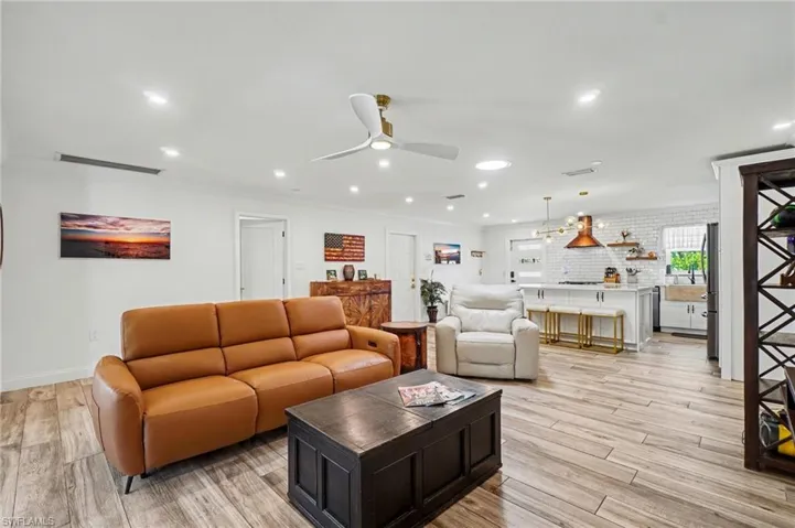 Open concept living space featuring wood-finish flooring, recessed lighting, and a contemporary ceiling fan