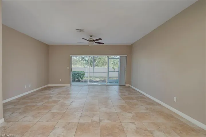 Spare room with a ceiling fan and light tile patterned floors