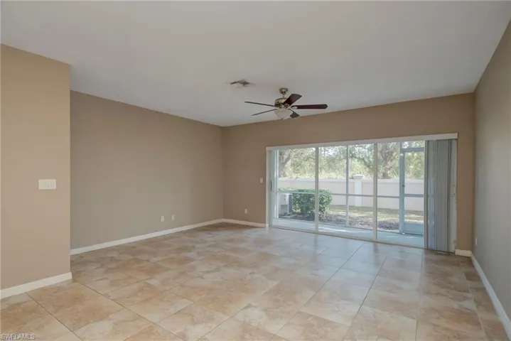 Spare room featuring baseboards and ceiling fan