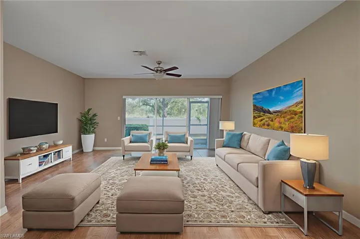 Living area featuring wood finished floors and ceiling fan
