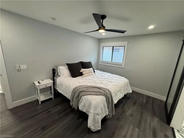 Bedroom featuring dark wood-style floors, ceiling fan, and recessed lighting